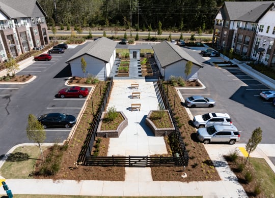 an aerial view of a yard with cars parked in a parking lot