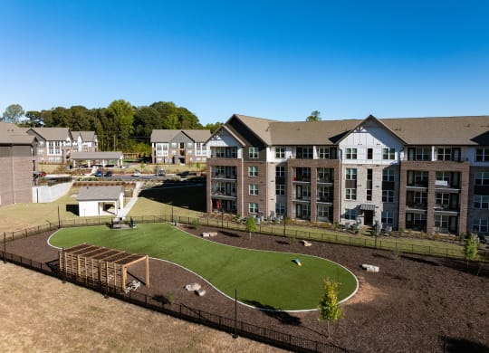 an aerial view of an apartment complex with a park and a playground