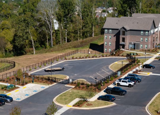 a parking lot with cars in front of a building