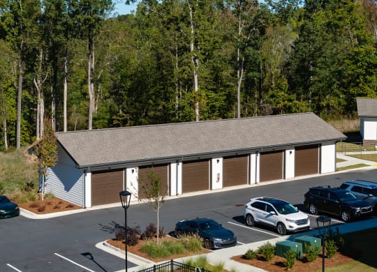 an aerial view of a building with cars parked in a parking lot