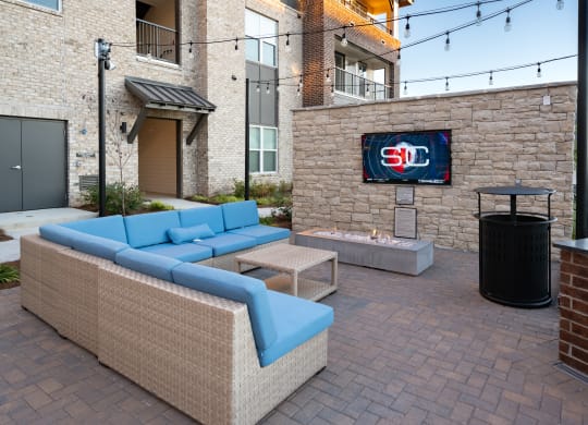 a living room with couches and a fire pit