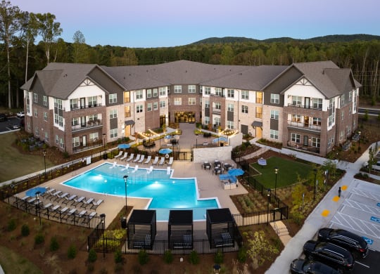 an aerial view of an apartment building and an outdoor pool