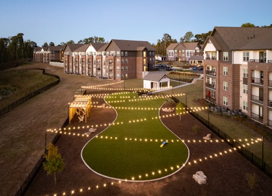 an aerial view of the courtyard at night with lights