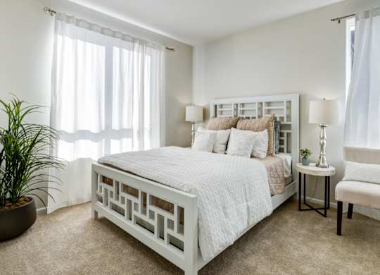 a bedroom with a bed and a chair