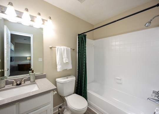 A bathroom with a toilet, sink, and bathtub.