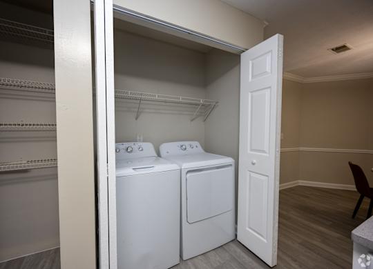 A laundry room with a washer and dryer in it.