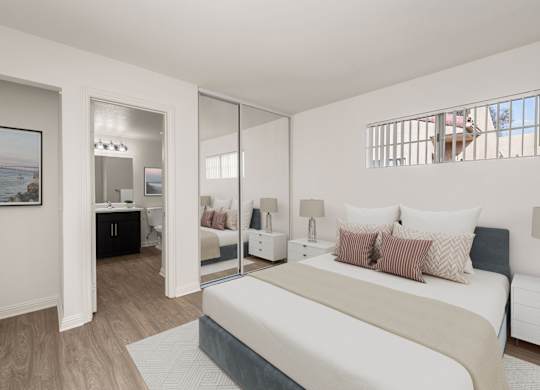A bedroom with a large bed and a painting on the wall.
