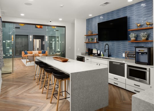 a kitchen with a large island and a counter top with chairs