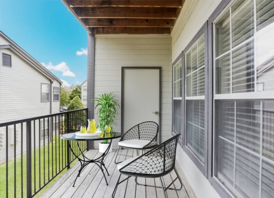 a balcony with a table and chairs and a door