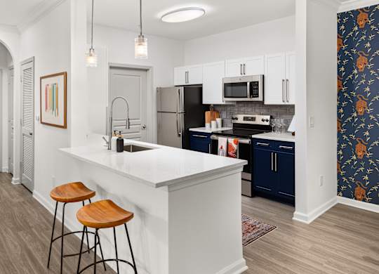 a kitchen with an island and two stools