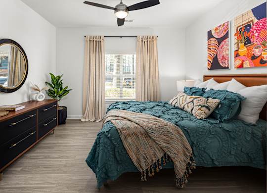 a bedroom with a bed and a dresser and a window