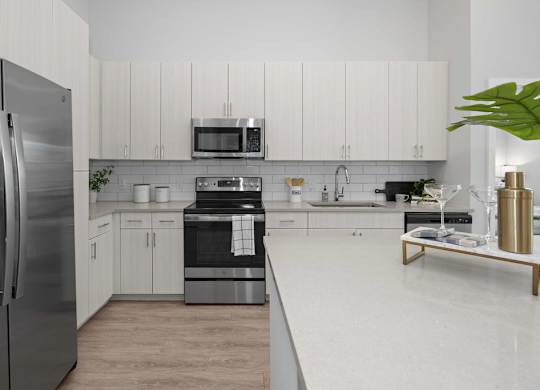 A modern kitchen with stainless steel appliances and white cabinets.