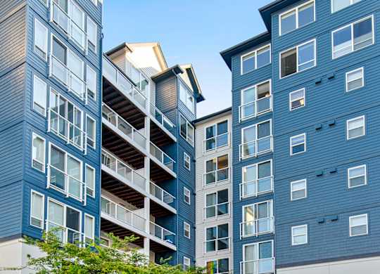 a group of modern buildings with a street in front of them