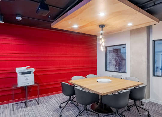 A conference room with a wooden table and chairs.at Axle, Seattle Washington 