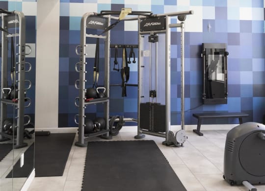 a home gym with blue and white tiles