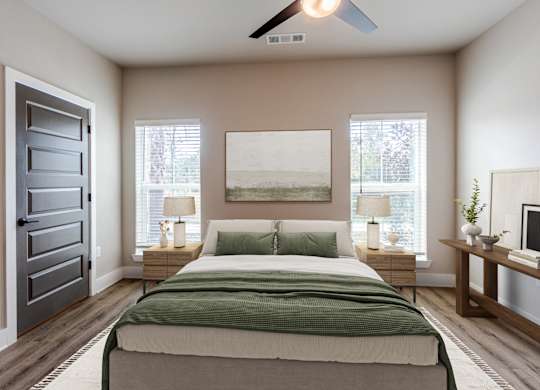 A bedroom with a bed, nightstands, and a ceiling fan.