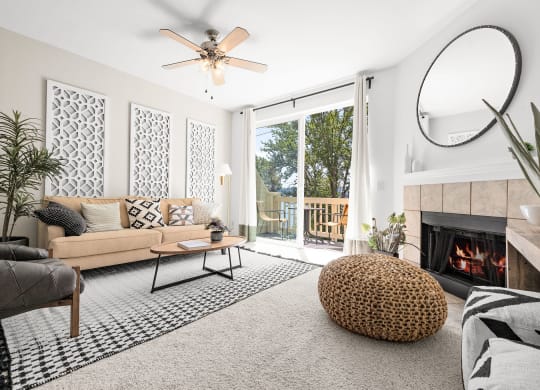 a living room with white walls and a sliding glass door leading to a balcony