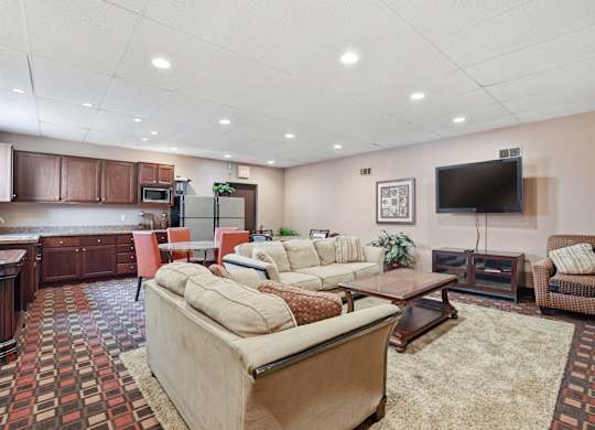 A living room with a large couch and a television.