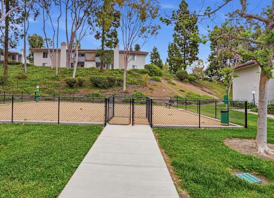 A playground with a slide and a fence.