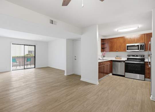 A kitchen with wooden cabinets and stainless steel appliances.