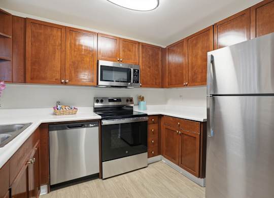 A kitchen with wooden cabinets and stainless steel appliances.