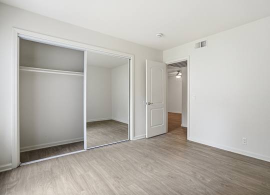A room with a white door and a white wall.