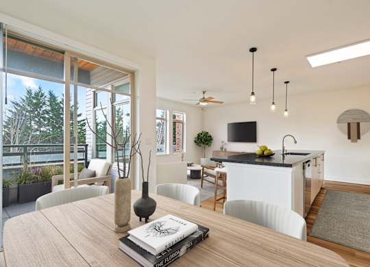 A modern kitchen with a dining table and chairs.