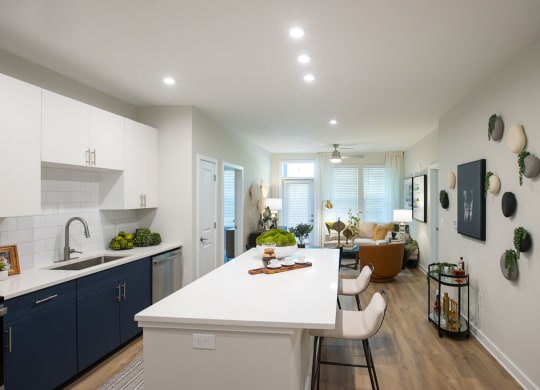 a kitchen and living room with a white counter top
