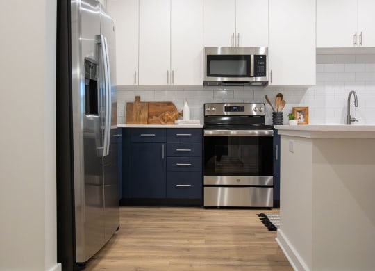 a kitchen with stainless steel appliances and white cabinets