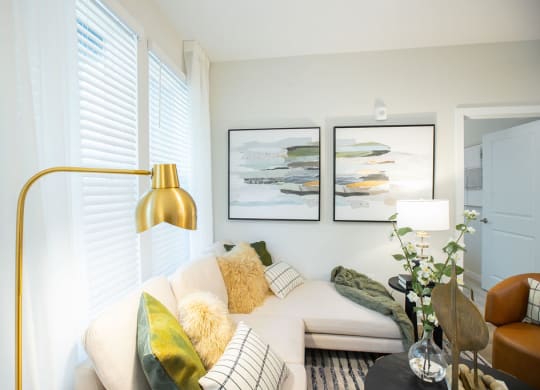 a living room with a couch and two pictures on the wall
