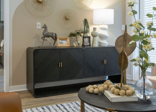 a living room with a cabinet and a table with spheres on it