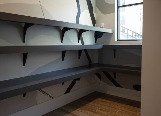 a large grey shelf in a room with a window