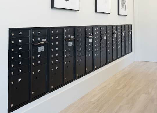 a lockers room with pictures on the wall and a wooden floor