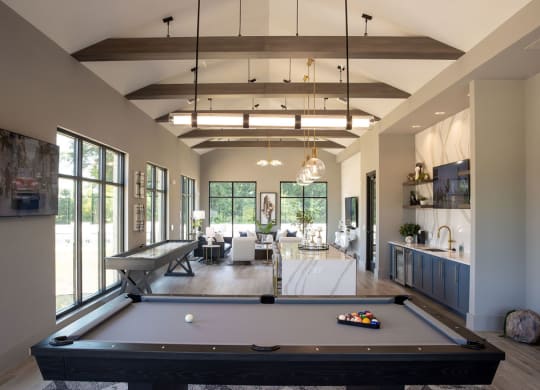 a pool table in the center of a living room
