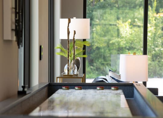 a living room with a table and a window