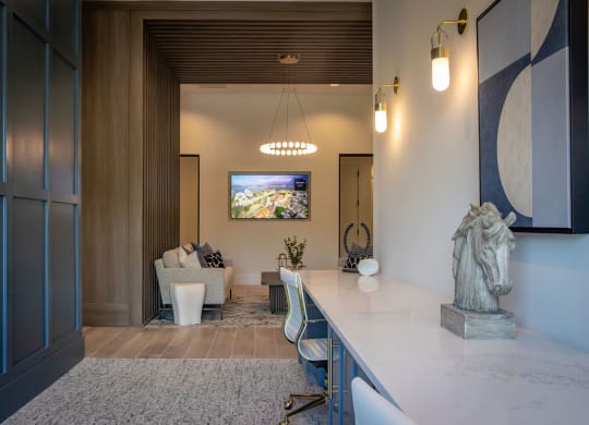 a kitchen with a marble counter top and a living room with a tv