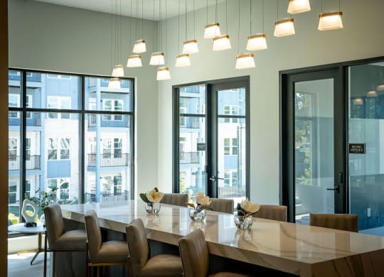 a large communal table in a conference room with large windows
