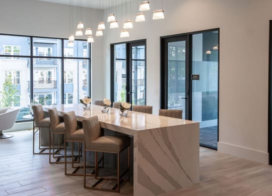 a dining room with a marble table and chairs in a lobby