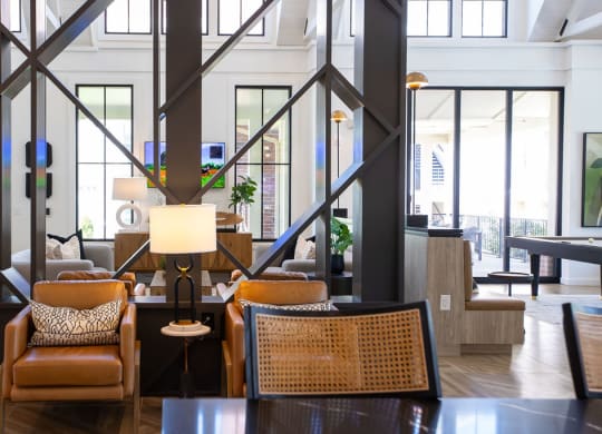 the lobby of a hotel with chairs and a table