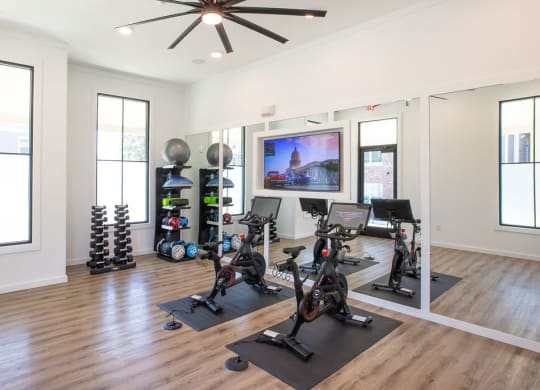 a home gym with weights and a tv on the wall