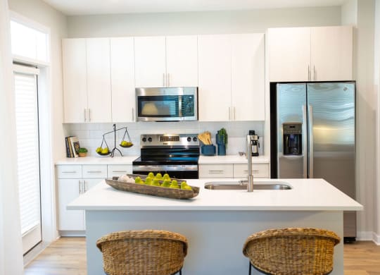 a kitchen with stainless steel appliances and white cabinets