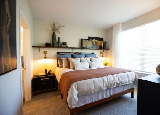 a bedroom with a bed and a window
