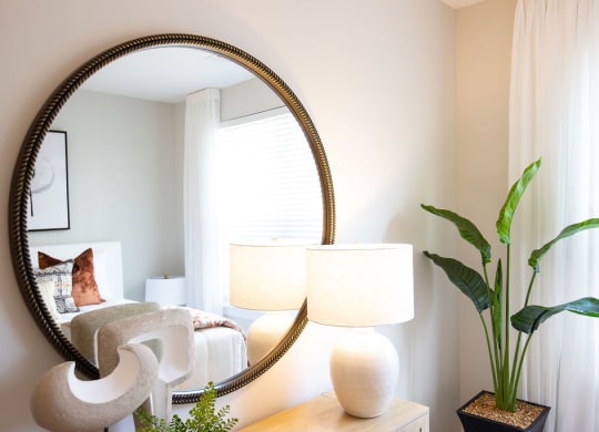 a bedroom with a large mirror on the wall