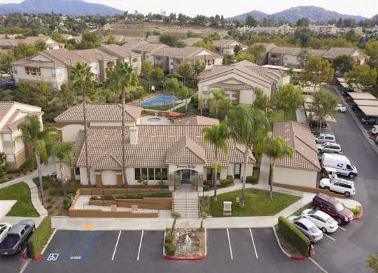 A large building with a pool in the middle of a parking lot.