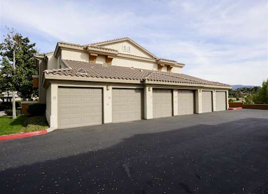 A large house with a grey roof and a grey garage door.