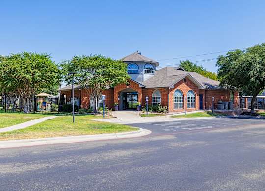 a large brick building with a grey roof at Clear Creek Meadows Apartments, Apartments, Copperas Cove, TX
