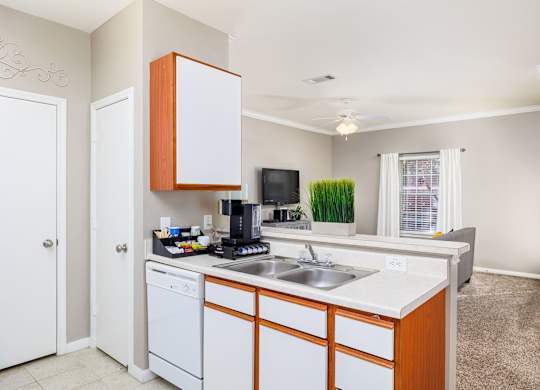 A kitchen with white cabinets and a white dishwasher at Clear Creek Meadows Apartments, Apartments, Copperas Cove, TX