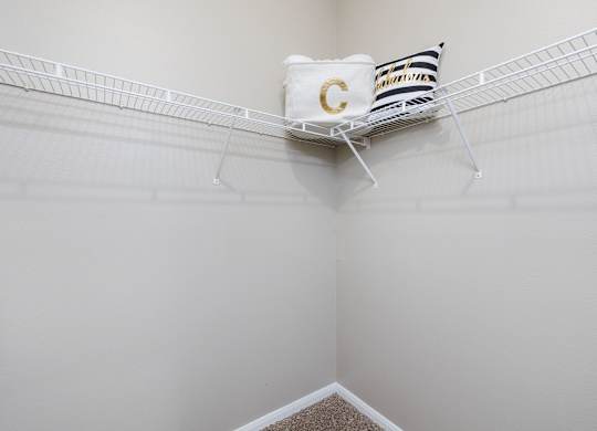 A white shelf with a pillow and a bag with the letter C on it at Clear Creek Meadows Apartments, Copperas Cove, Texas