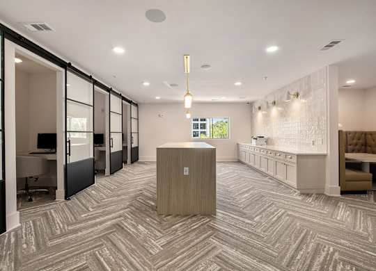 A modern office space with a reception desk and a view of the outdoors.