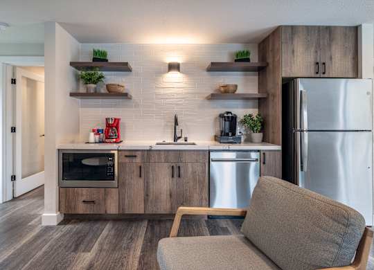 a kitchen with stainless steel appliances and a stainless steel refrigerator